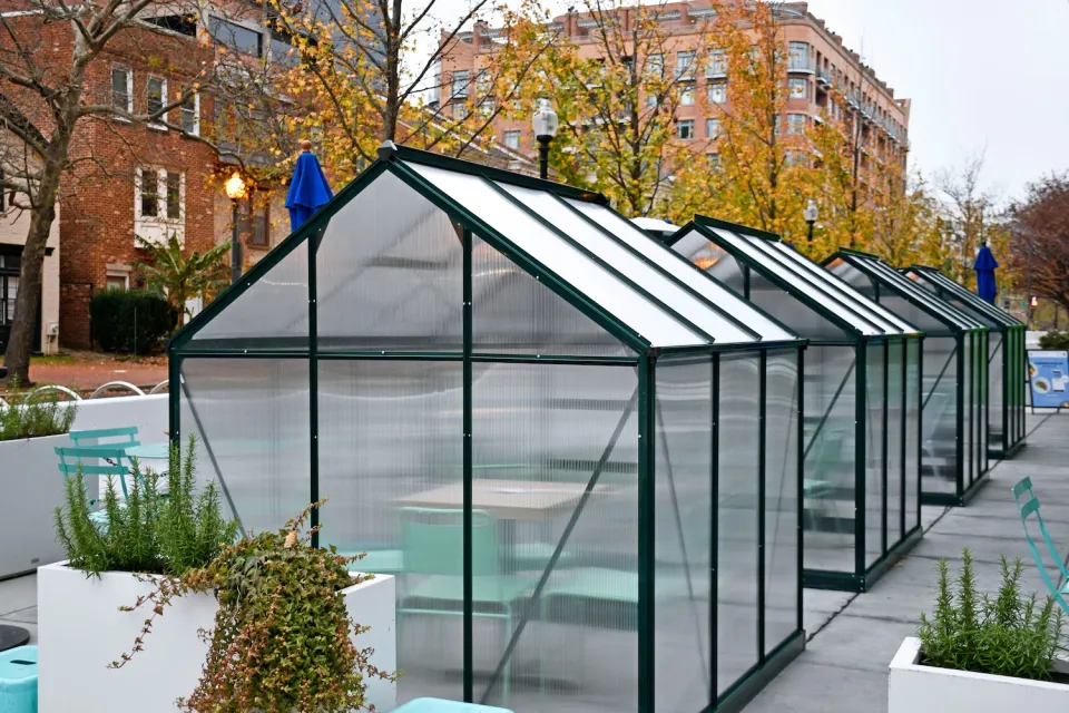 Frosted plexiglass kiosks for outdoor dining installed on Washington DC sidewalk.